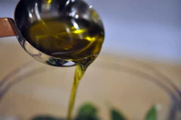 Slowly add the olive oil