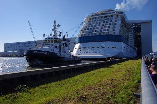 Celebrity Reflection and tugboat