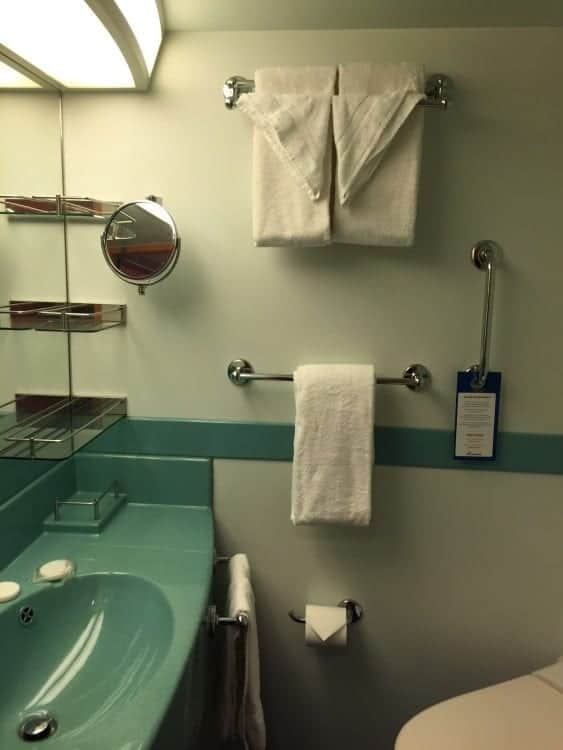 Ample countertop and shelf space in this bathroom. Love the magnifying mirror.