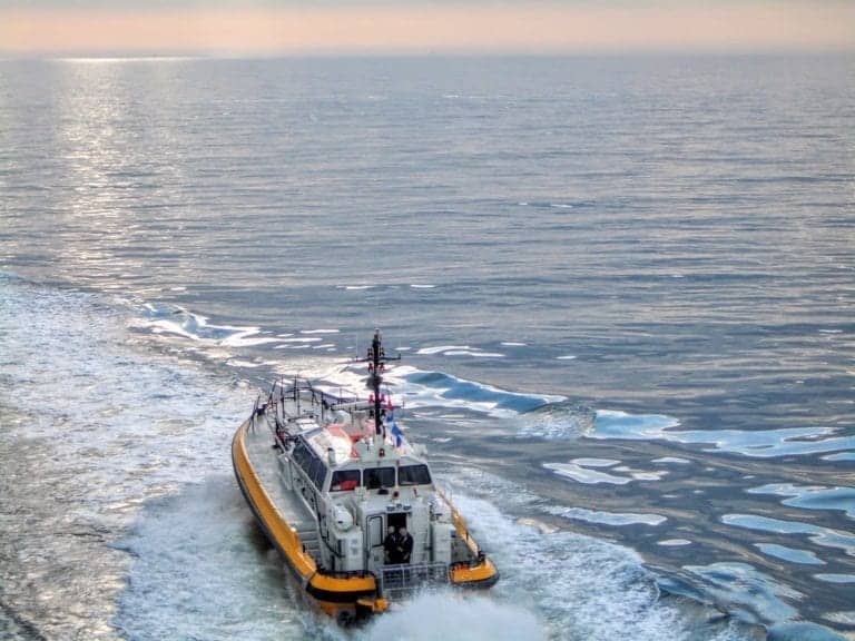 Tug boat leaving port of Helsinki Finland