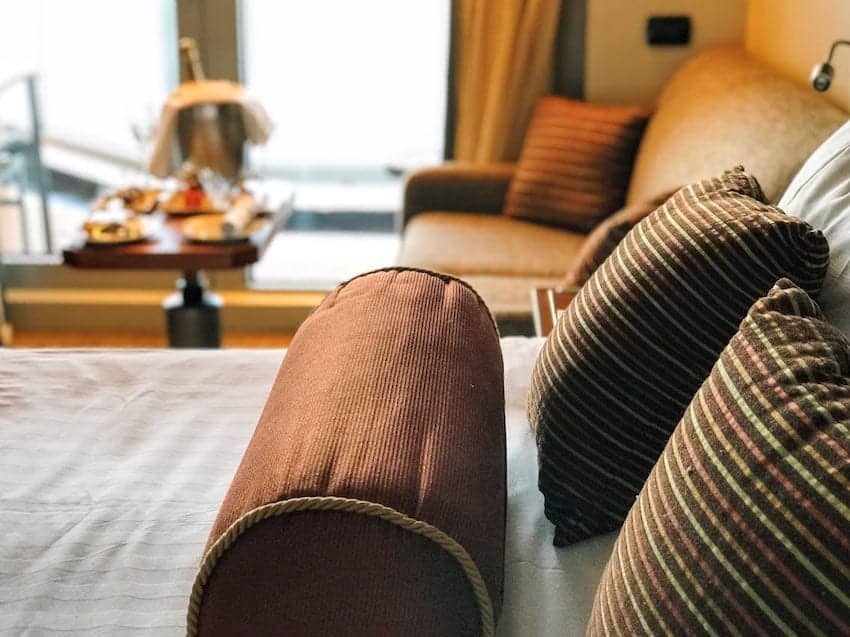 Close-up photo on bed pillows and sofa.