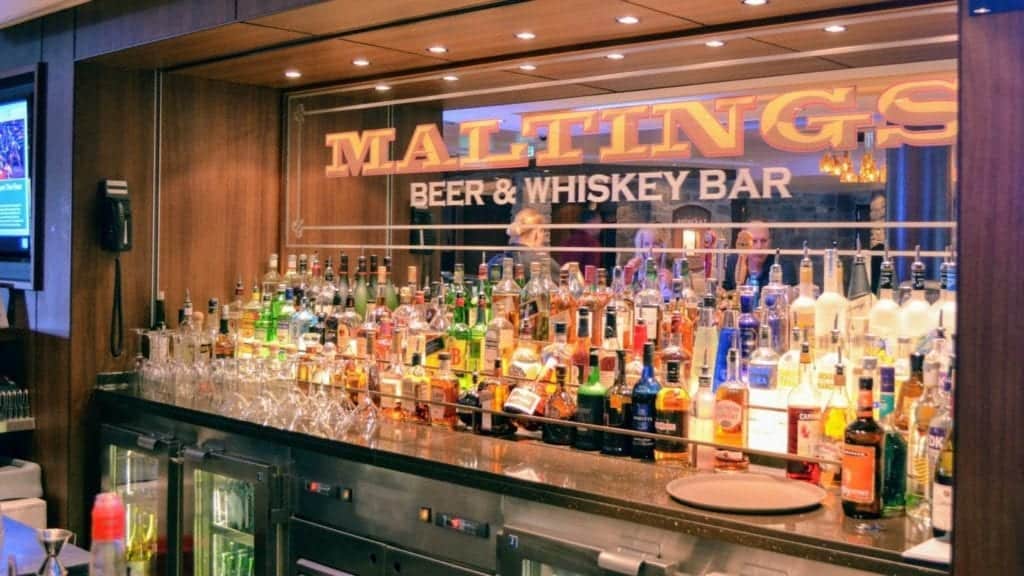 Maltings Beer and Whiskey Bar with collection of liquor bottles. 
