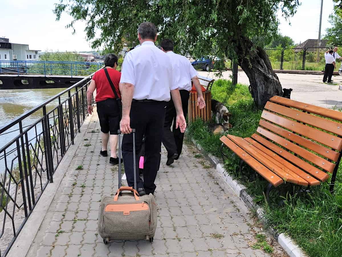 Ship's doctor rolling my small carryon bag to the ship.