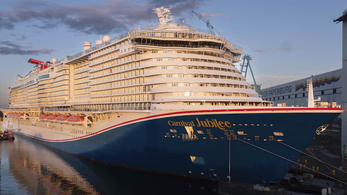 Carnival Jubilee at docked at pier at shipyard in Germany.