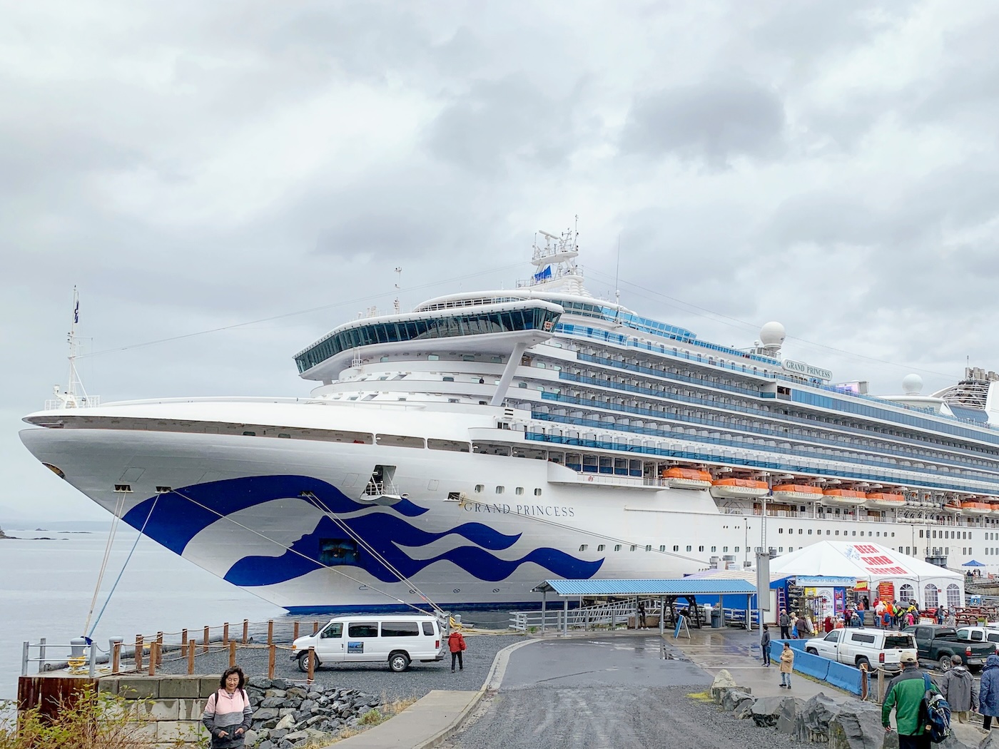 Grand Princess docked in Sitka, Alaska with passengers walking to and from the ship.
